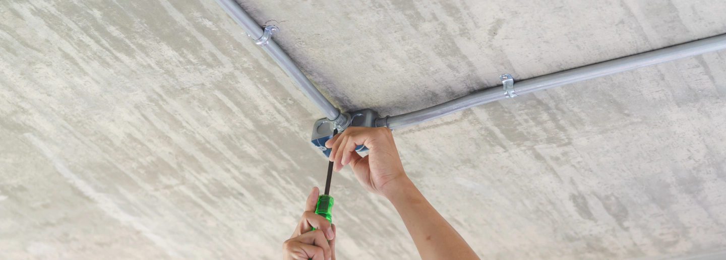 view of an electrician working on an electrical system in a commercial building newport mi